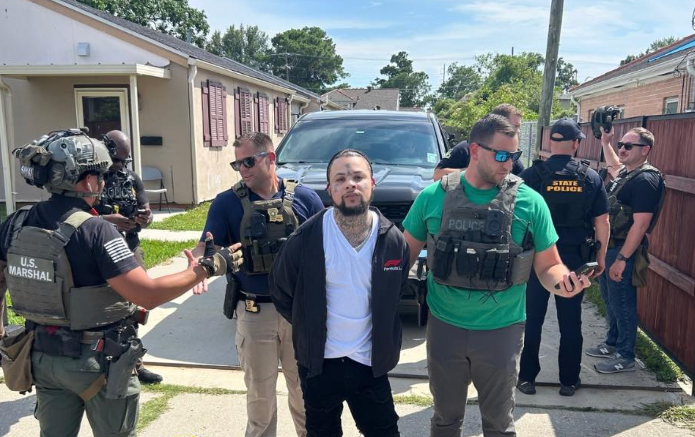 Massey looked directly into the camera as law enforcement photographed his arrest.