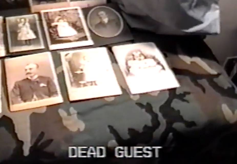The ominous video shows black and white photographs of unknown people, captioned: “DEAD GUEST”