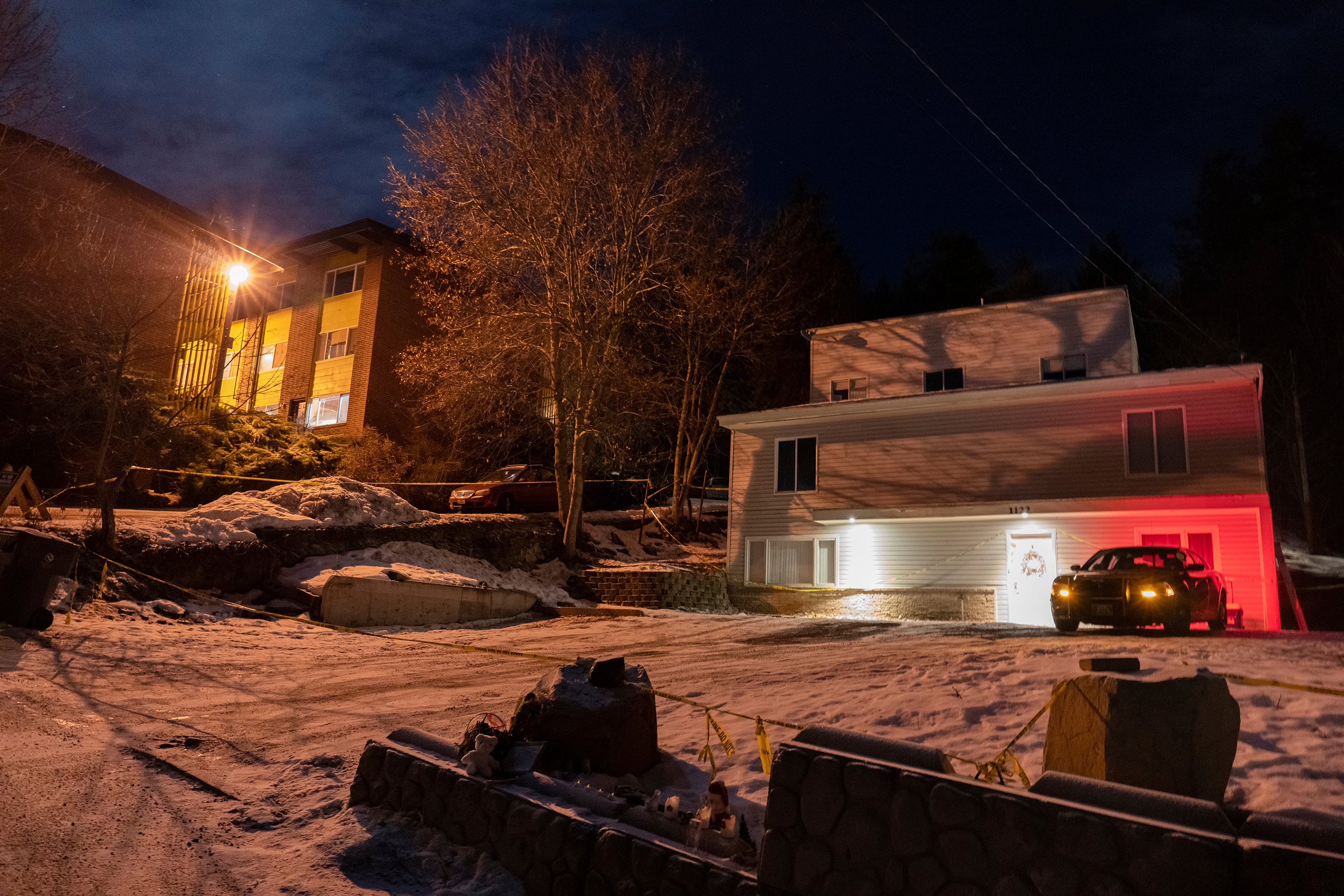 A private security officer sits in a vehicle on Jan. 3, 2023, in front of the house in Moscow, Idaho where four University of Idaho students were murdered