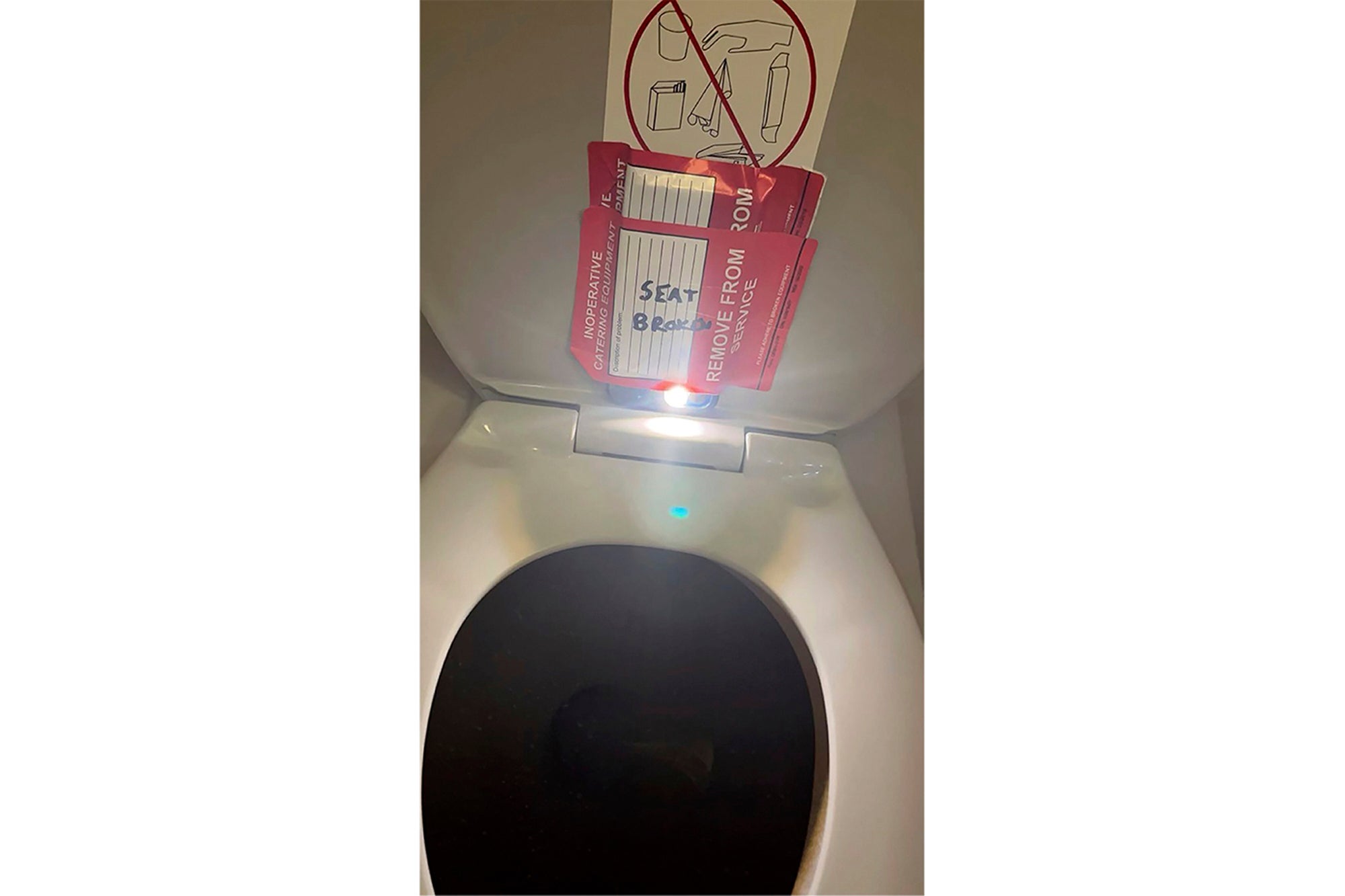 In this photo provided by the law firm Lewis & Llewellyn LLP, an iPhone is taped to the back of a toilet seat on an American Airlines flight from Charlotte, N.C., to Boston, Sept. 2, 2023. (Lewis & Llewellyn LLP via AP, File)