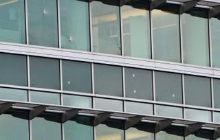Windows on a CDC building pockmarked by bullet holes. The gunman struck at least four CDC buildings