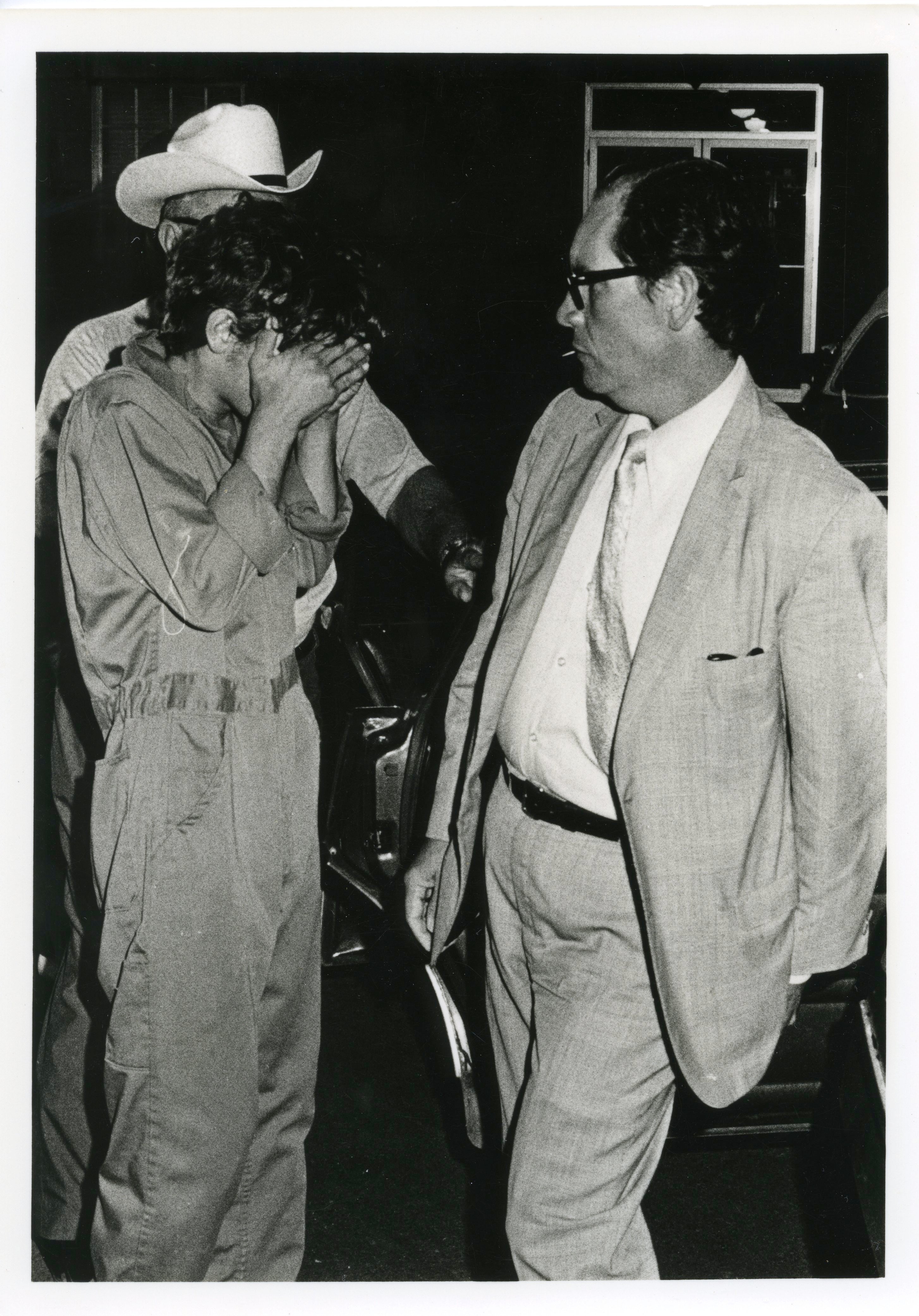 Henley, who was 17 at the time of his arrest, covered his face to hide from the media