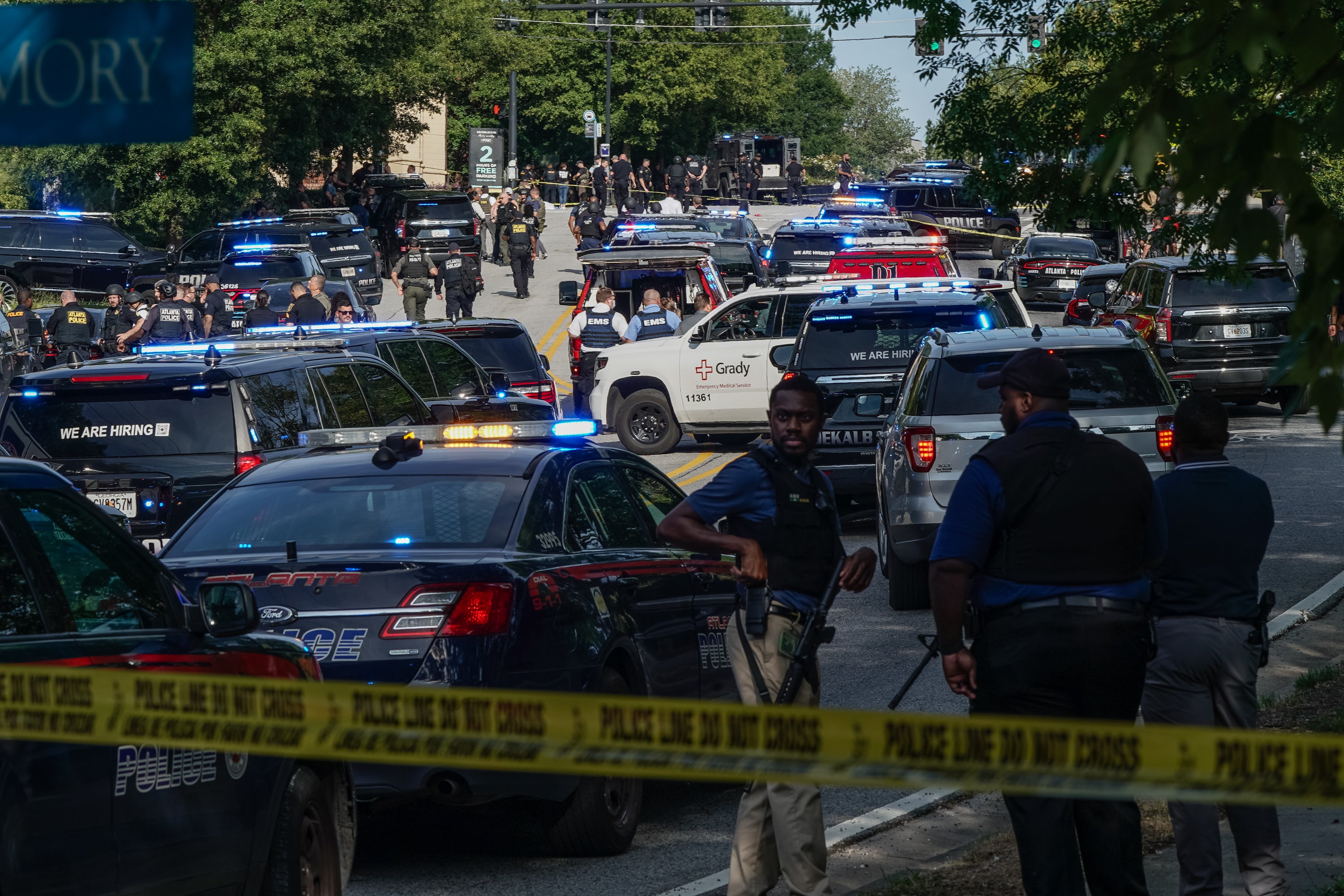 Police gather near the Centers for Disease Control and Prevention campus in Atlanta, Georgia after a nearby gunman opened fire, killing an officer and striking several agency buildings