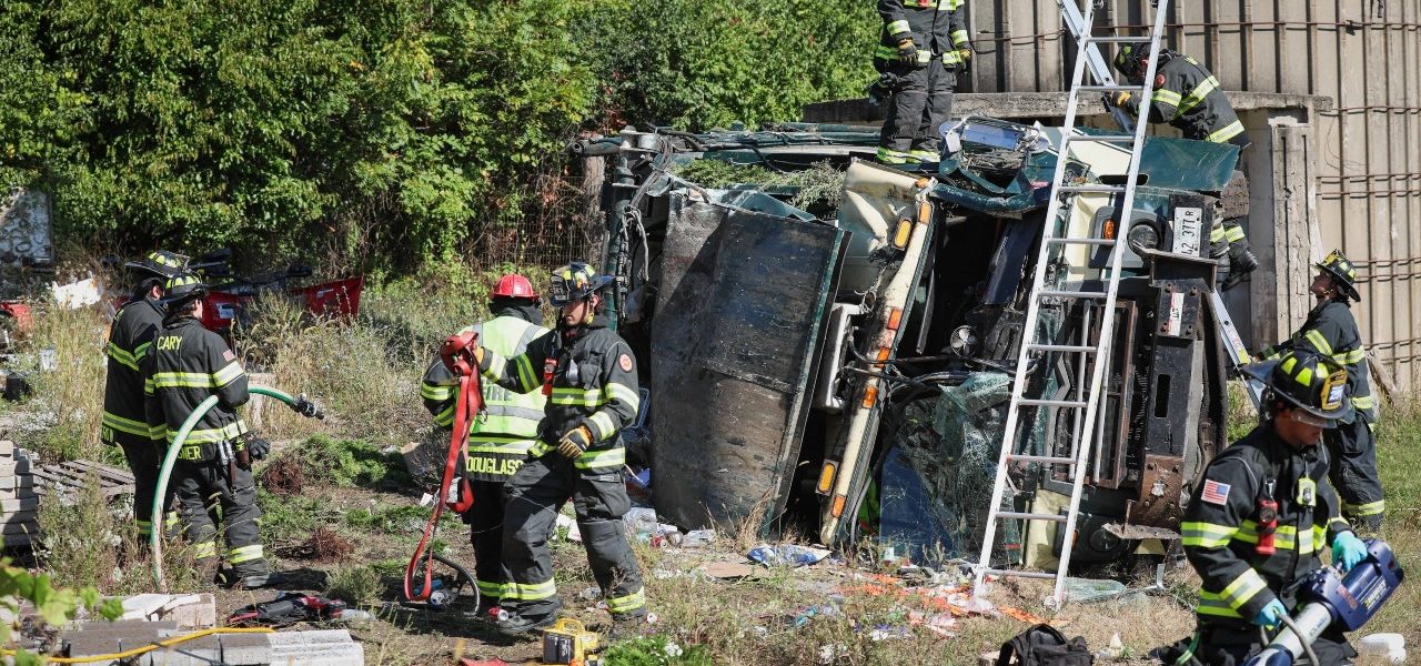 Garbage truck driver extricated after rollover crash in Unincorporated Cary