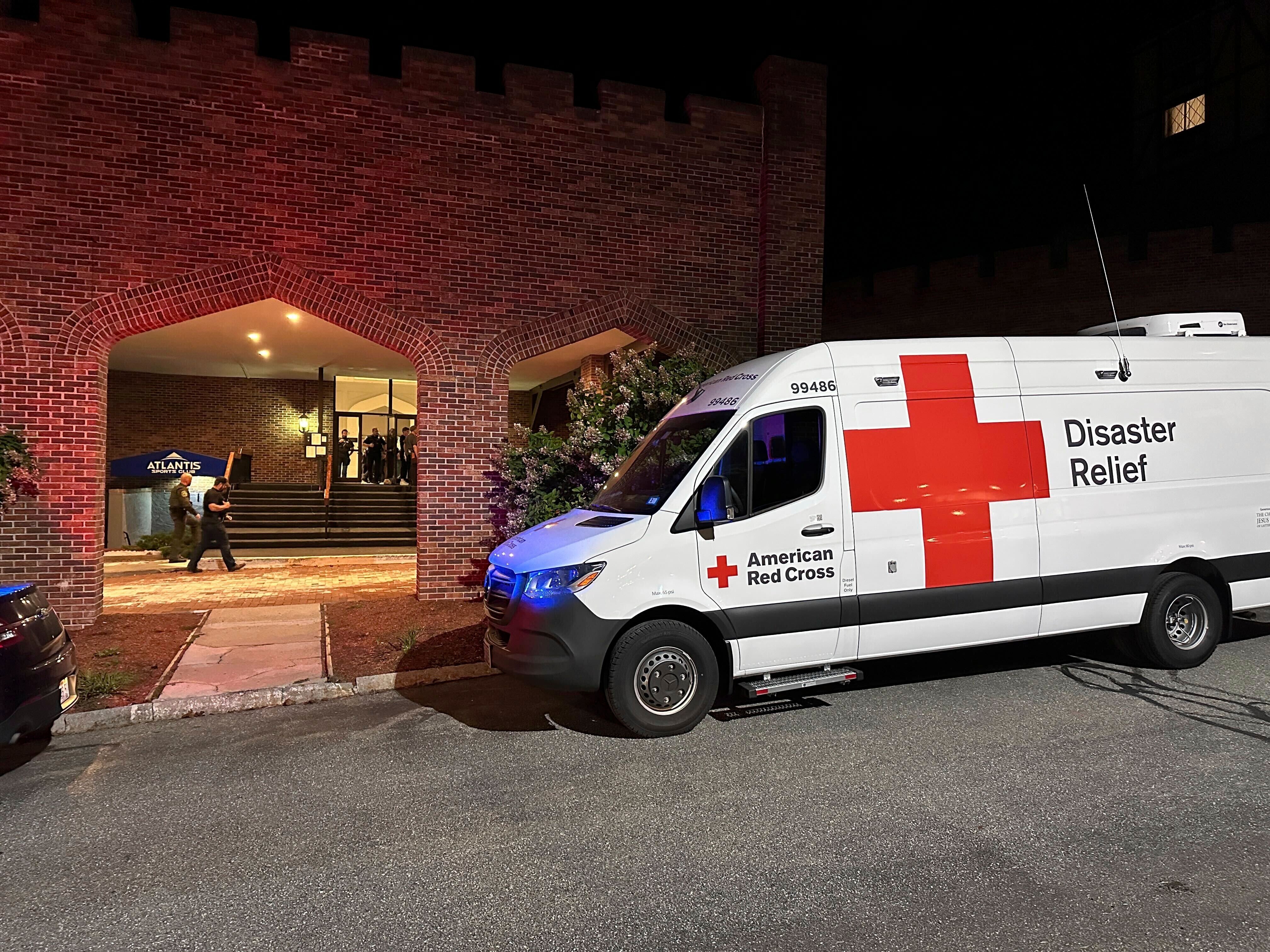An American Red Cross Disaster Relief van is parked outside a hotel that is acting as a reunification center after a shooting at a country club in Nashua, New Hampshire, Saturday, Sept. 20, 2025. (AP Photo/Michael Casey)