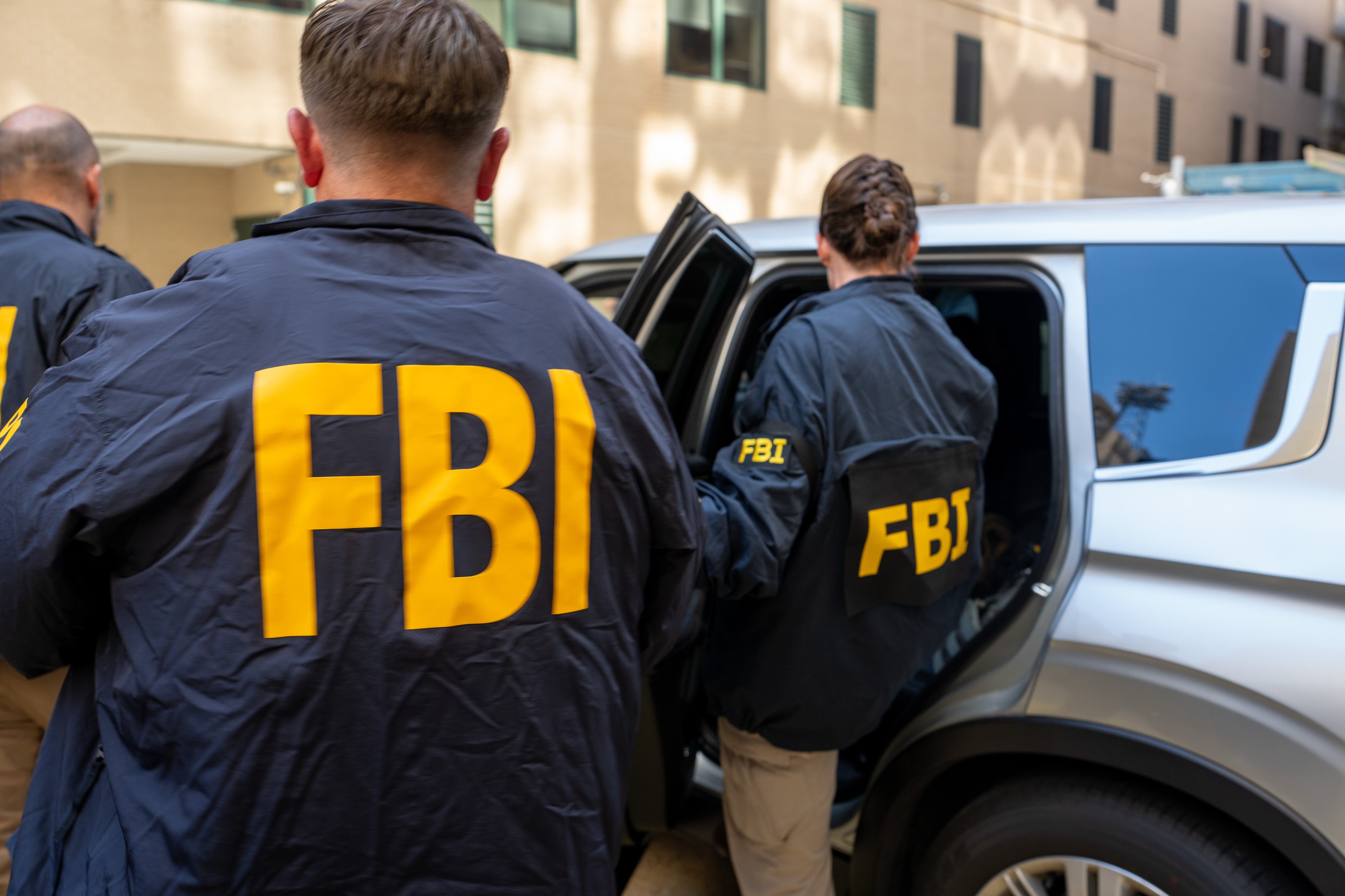 The Ring camera captured the three men wearing FBI jackets (not pictured)