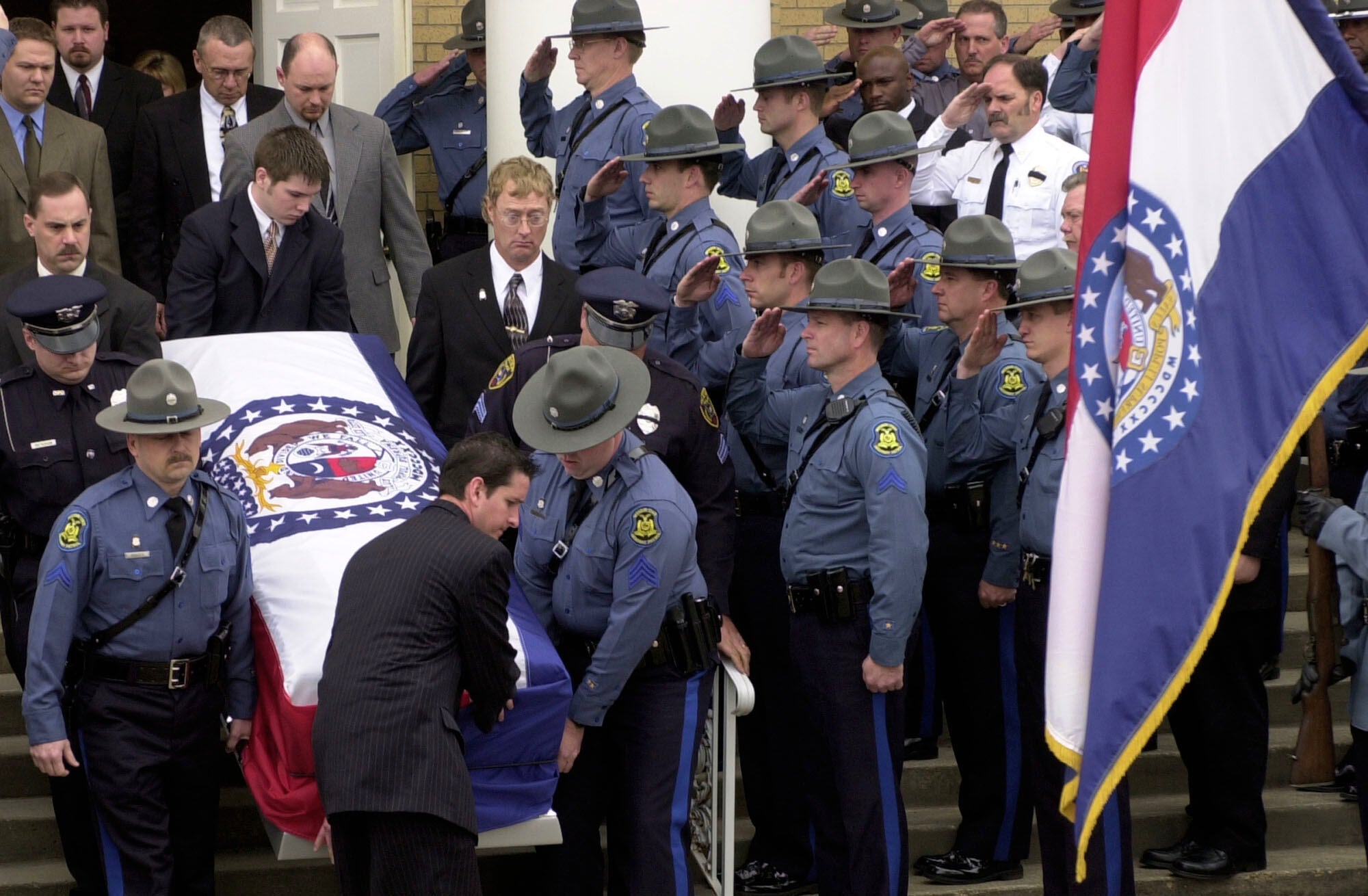 Members of the Missouri State Highway Patrol salute the body of fellow officer Sgt. Carl ''Dewayne'' Graham Jr., after funeral services March 24, 2005, in Dexter, Mo. (AP Photo/Bill Boyce, File)