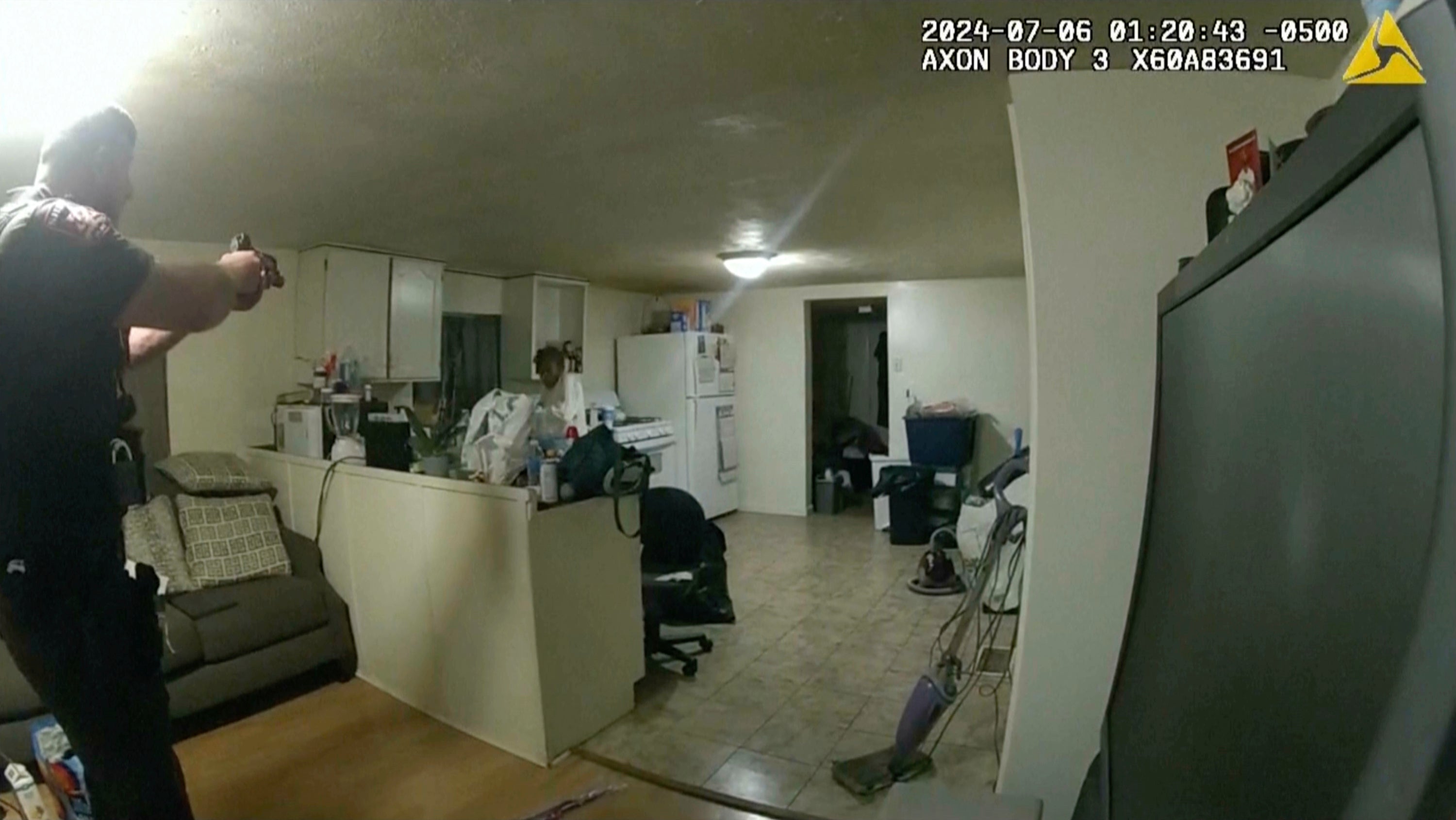 Former Sangamon County Sheriff's Deputy Sean Grayson points his gun at Sonya Massey in her kitchen
