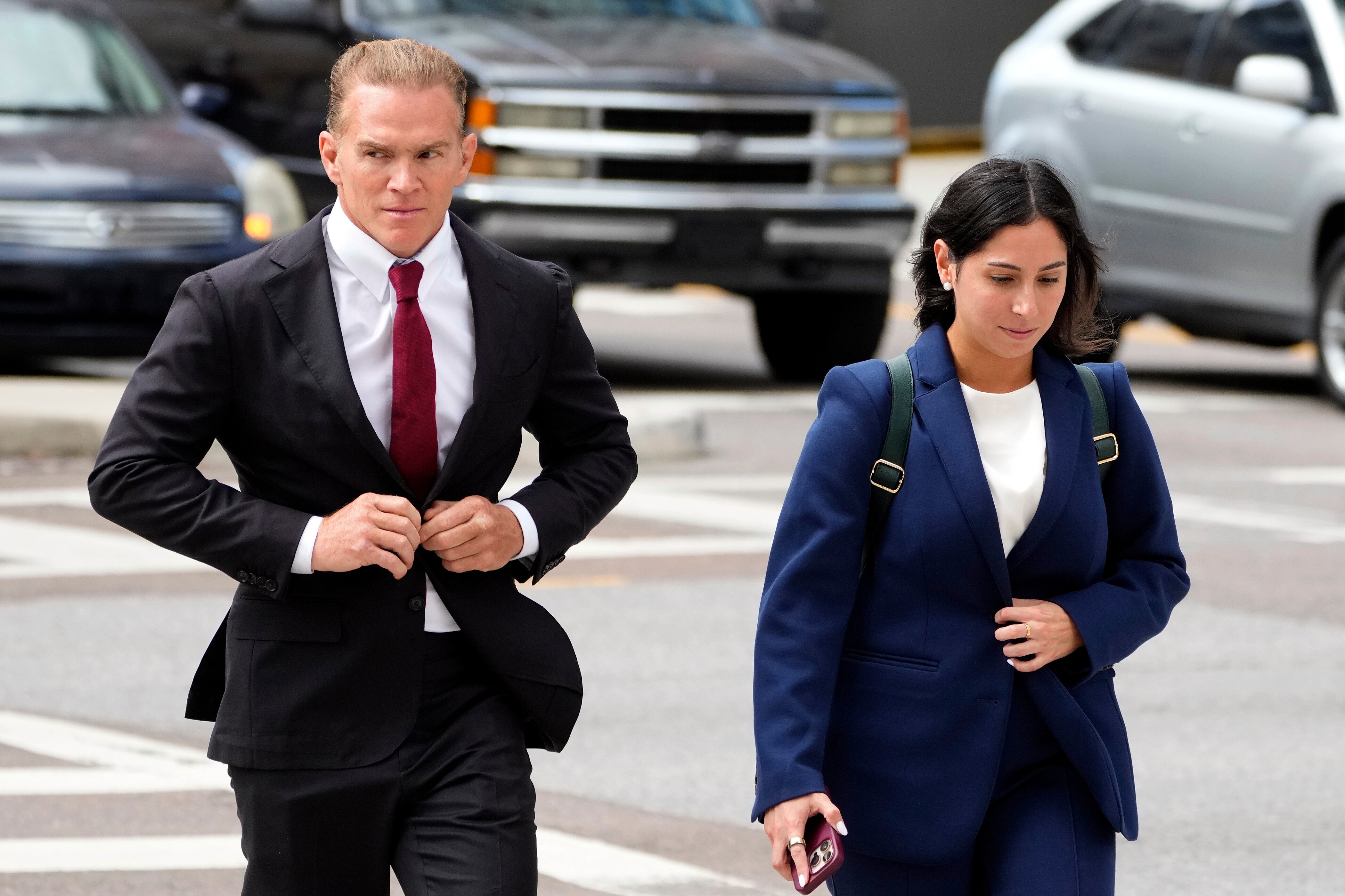 Former Green Beret Jordan Goudreau, left, walks to the United States Courthouse for a bond hearing in Tampa, Fla., Wednesday, Oct. 29, 2025. (AP Photo/Chris O'Meara)