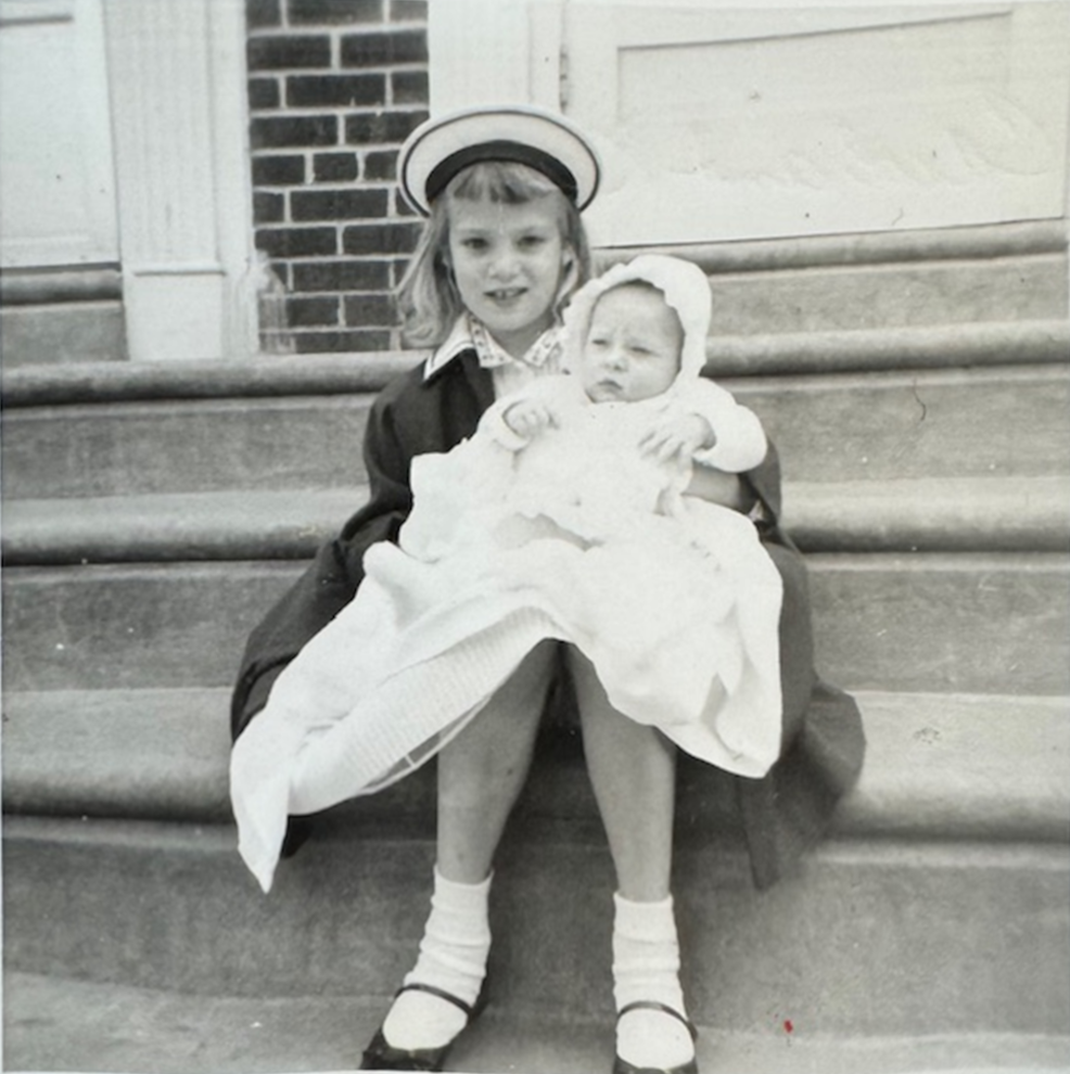 Carol Ann Dougherty is seen holding her baby sister, Kay Talanca, in an updated photo